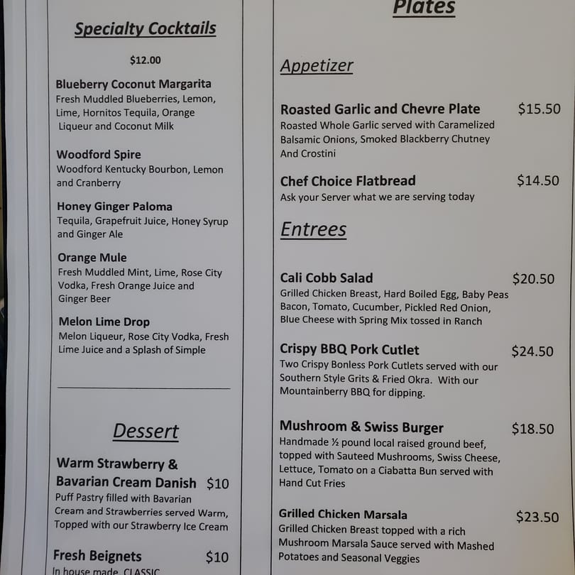 Restaurant menu displaying specialty cocktails, appetizers, entrees, and desserts with prices.